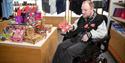 A person in a wheelchair looking around the gift shop at Strawberry Field