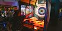 a person playing in the arcade at The Grand Pier