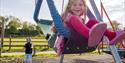 A child in the swing at the play area at Noah's Ark Zoo Farm