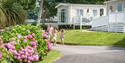 Family walking past the lodges at John Fowler Holiday Parks