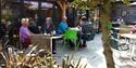Customers sitting on garden patio at Steff's Kitchen at Fairweather's Garden Centre in the New Forest