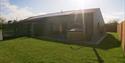 Outside Mountain Lodge showing the lawn and the hot tub
