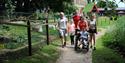 Family exploring Thrigby Hall Wildlife Gardens, with one child in a wheelchair