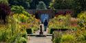 A couple walking through Hemsley Walled Garden