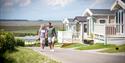 Couple walking through the park on a summer day John Fowler Holiday Parks