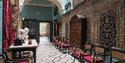 A corridor at Mount Stewart – National Trust showing tiled floors, patterned walls and chairs  ©National Trust Images/Andreas von Einsiedel