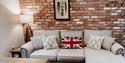 Sofa in the living room at Sandhole Cottages