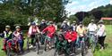 large group of cyclists including accessible bikes at Dalby Forest Cycle Hub CIC