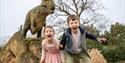 Two children with a dinosaur at West Midlands Safari Park
