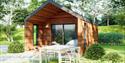 Glamping lodge at Coniston Park Coppice with dining table outside among the trees