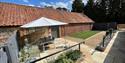 table and chairs out in the garden with a gazebo over the chairs at Sparham Hall Farm Holidays
