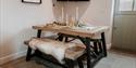 Table in the kitchen made up for dinner at Sandhole Cottages