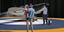 Person holding child looking at an aeroplane outdoors at Imperial War Museum Duxford