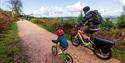 a man and small child riding bikes at Haldon Forest Park