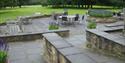 Gardens with seating areas and ramps at Rudding Park Hotel