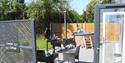 Decking outside the Coastal Cottage with bbq, table and chairs and hot tub