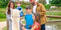 A family walking an alpaca at Fairytale Farm