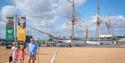 Family visiting The Historic Dockyard Chatham with a ship in the background
