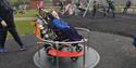 A child in a wheelchair in the wheelchair friendly play area  at Noah's Ark Zoo Farm