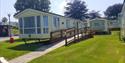 Adapted caravan at John Fowler Holiday Parks showing the wheelchair ramp up to the door