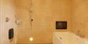 bathroom with wet room style shower and bath at The Granary, Larkbeare Grange