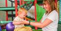 A parent and child in the soft play at Noah's Ark Zoo Farm