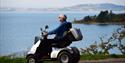 A person riding an all terrain mobility scooter around the lakes at Mount Stewart – National Trust ©National Trust Images/Chris Lacey