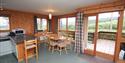 woodcombe cottages living room and kitchen with double doors leading out onto the decking