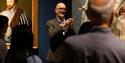 A talk taking place at the National Portrait Gallery in front of a portrait