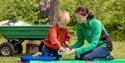 Staff at Bedgebury National Pinetum and Forest working with a child at workshops