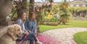 Two people sat with their dog in the gardens at Mount Stewart – National Trust ©National Trust Images/Christopher Heaney