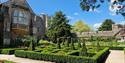 The gardens and outside of the Bishop’s Palace on a sunny day