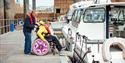 Visitor in a wheelchair boarding a boat in Jersey