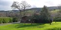 outside woodcombe cottages, with the cottage surrounded by gardens