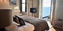 Double room at Watersmeet Hotel with view through open door to the ocean