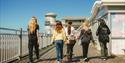 people walking along The Grand Pier