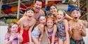 Aa group of children with two adults in swim wear at the Wave