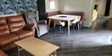 Living space and dining table with leather sofas and recligning chair