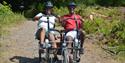 A couple riding an adapted bikle at Calvert Exmoor