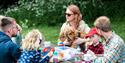 Family enjoying a picnic at Staunton Harold