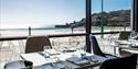 Tables set ready for dinners with views across the bay from Oyster Box