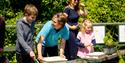 A group of children taking part in an activity with a member of staff at WWT Arundel Wetland Centre