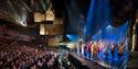 A performance taking place at Sadler’s Wells, with audience members applauding the actors on stage