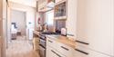Kitchen space with hob, oven and storage in an accessible caravan at Beverley Holidays