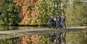 A group following the paths through the water at WWT Martin Mere Wetland Centre, three on foot and one in a wheelchair