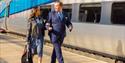 transpennine member of staff helping a blind passenger access the train