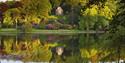 Temple of Apollo from across the lake, with temple reflected in the water at National Trust Stourhead. Credit National Trust Images Clive Nichols