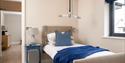 A single bed with hoist above