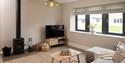 living room with log burner, television and sofa