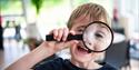 child with magnifying glass at Winchester Science Centre and Planetarium